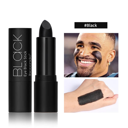 Black eye black stick with packaging and application on a man's eyelid.