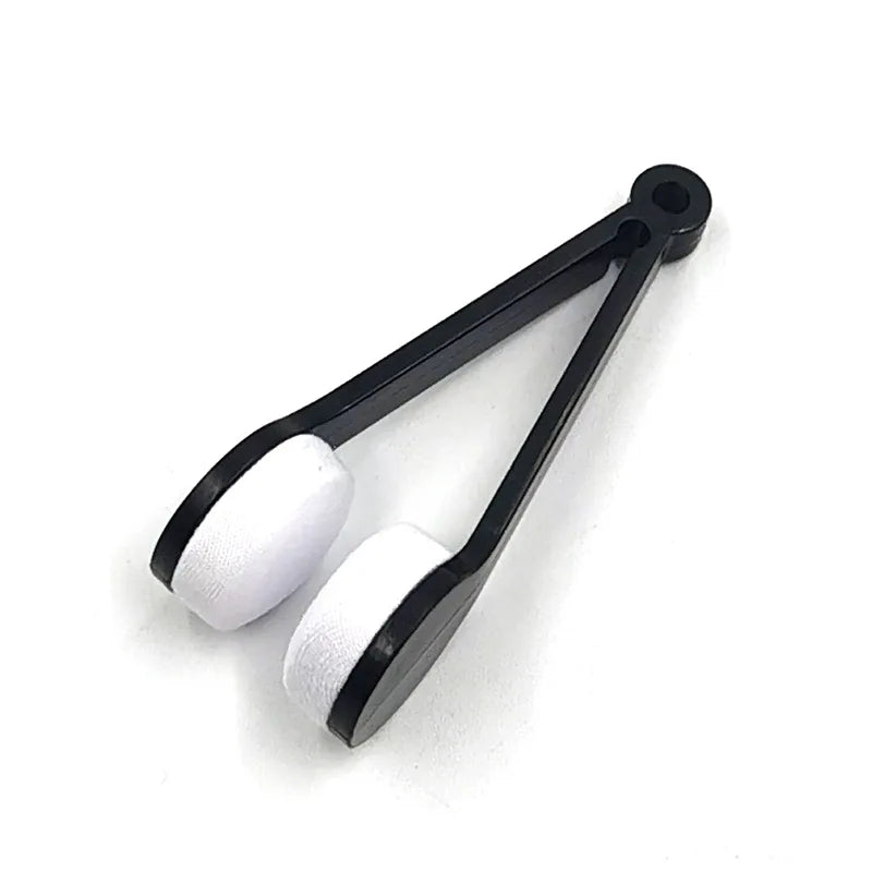 Black tongs with white silicone tips on a white background