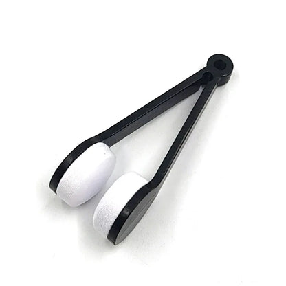 Black tongs with white silicone tips on a white background